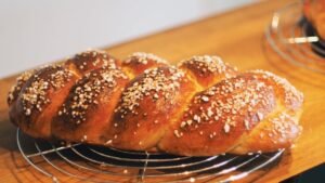 Close-up of a freshly baked challah bread with a golden crust, perfect for cultural and culinary themes.