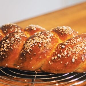 Close-up of a freshly baked challah bread with a golden crust, perfect for cultural and culinary themes.