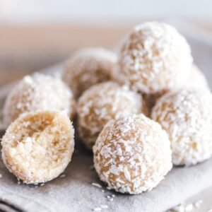 A close-up of coconut bliss balls on a linen cloth, showcasing their texture and sweet appeal.